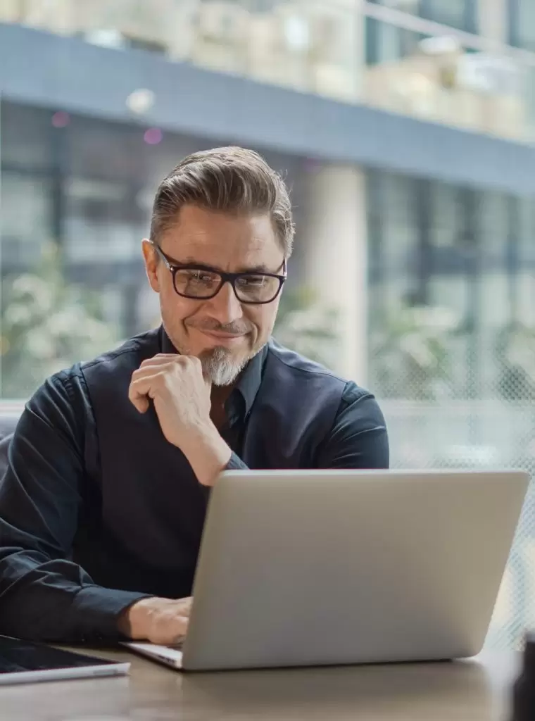 Businessman,Using,Laptop,Computer,In,Office.,Happy,Middle,Aged,Man,